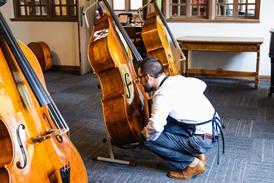 Luthier examining instrument