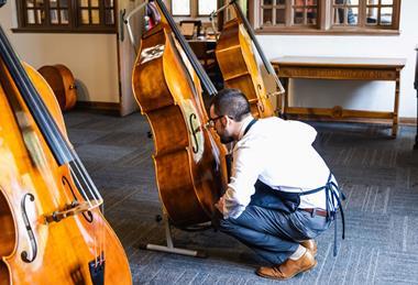 Luthier examining instrument