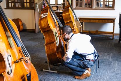 Luthier examining instrument