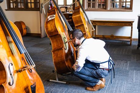Luthier examining instrument