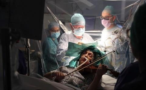 Dagmar Turner, 53, plays the violin during her brain surgery. Image: ITV News