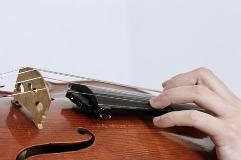 The Digitaize system fits under a violin fingerboard