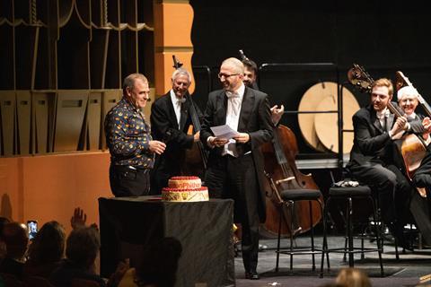 Great British Bake Off 2021 Semi-Finalist Jürgen presents London Philharmonic Orchestra with a 90th birthday cake